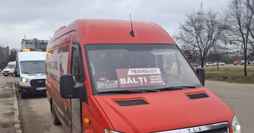 A red intercity minibus in Moldova with a destination sign for Balti.