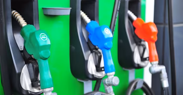 Close-up of fuel pump nozzles at a gas station.