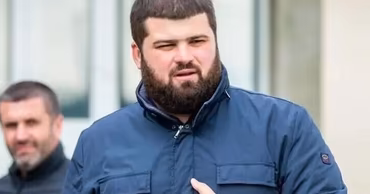 Grigori Uzun, a Moldovan politician, standing outdoors.