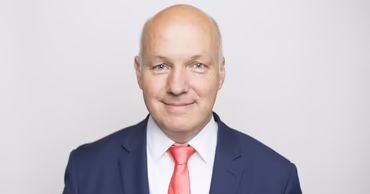 Portrait of Czech Senator Pavel Fischer wearing a blue suit and red tie.