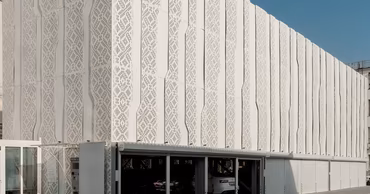 A modern multi-level parking structure with a decorative white facade.