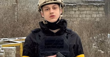 Nikolai Lebedev wearing a tactical helmet and vest with a firearm.