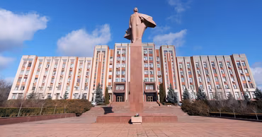 The Supreme Council building in Tiraspol with a Lenin statue in front.