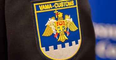 Close-up of the Moldovan Customs Service emblem on a uniform sleeve.