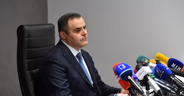Vadim Ceban, head of Moldovagaz, sitting at a press conference table with microphones.