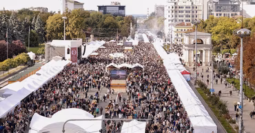 Aerial view of the National Wine Day festival in Chisinau with many people and white tents.