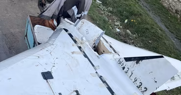 A crashed Gerbera drone wreckage loaded in a small trailer on a rural road.