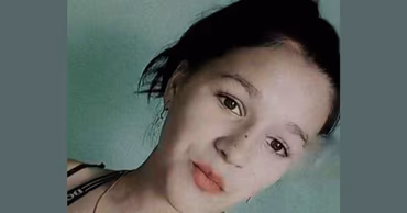 A portrait of a young girl with dark hair.