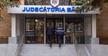 Two police officers entering the Balti court building in Moldova.