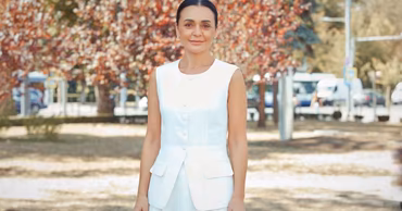 Portrait of Moldovan politician Elena Gritco standing outdoors.