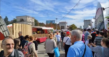 Crowd of people at the National Wine Day festival in Chisinau's Great National Assembly Square.