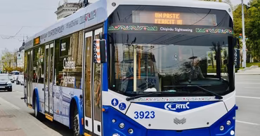 A modern Chisinau trolleybus driving on a city street.