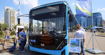 A modern blue electric trolleybus displayed at an outdoor public event in Moldova.