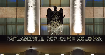 The facade of the Parliament building of the Republic of Moldova at night.