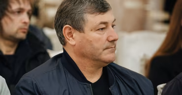 Ivan Kylchik sitting in a room during an event.