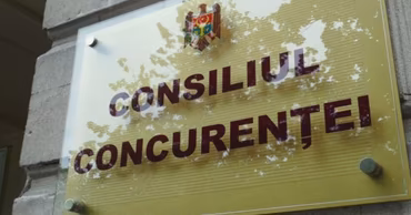 The sign of the Competition Council of Moldova on a building wall.