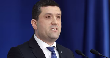 Romanian politician Radu Miruță speaking at a press conference.