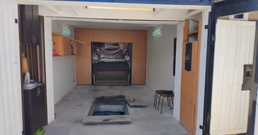 An open garage with a cellar hatch on the floor, where a man died from carbon dioxide.