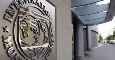 The official logo of the International Monetary Fund mounted on a building wall.