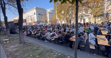 Crowds of people sitting at outdoor tables during a public festival in Chisinau.