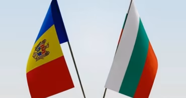 The national flags of Moldova and Bulgaria placed side by side on a table.