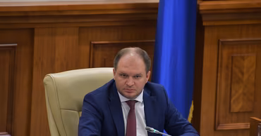 Ion Ceban sitting at a desk in an office setting.