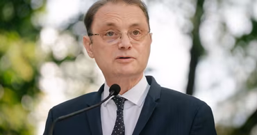 Portrait of Romanian politician Luca Niculescu speaking at a microphone.