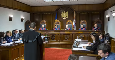 A courtroom scene in Moldova with judges and lawyers during a legal proceeding.