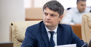 Andrei Spînu sitting at a table during a meeting.