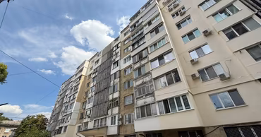 A low-angle view of a multi-story residential apartment building in Chisinau.